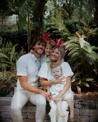 Witney Carson and her husband with their two sons