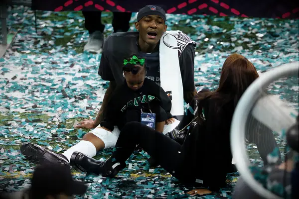 DeVonta Smith with his fiancée and daughter at Super Bowl LIX