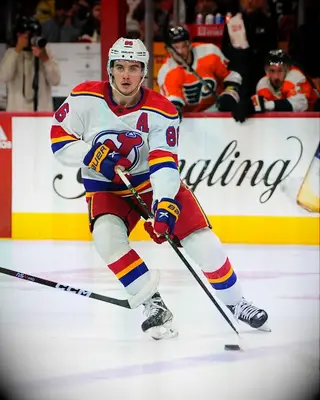 New Jersey Devils center Jack Hughes playing hockey