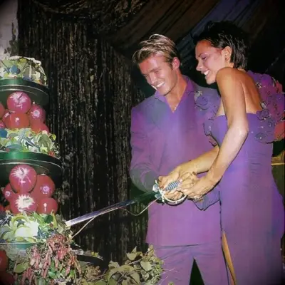David and Victoria Beckham cutting their wedding cake