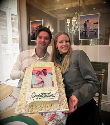 Patrick Schwarzenegger and finacee Abby Champion holding congratulations cake