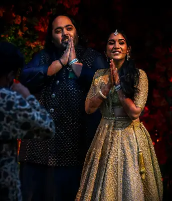 Getty caption: Radhika Merchant and Anant Ambani pose for the media during their engagement, at Antilia on January 19, 2023 in Mumbai, India.
