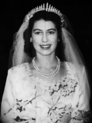 Closeup bridal portrait of Queen Elizabeth wearing tiara and pearls on wedding day