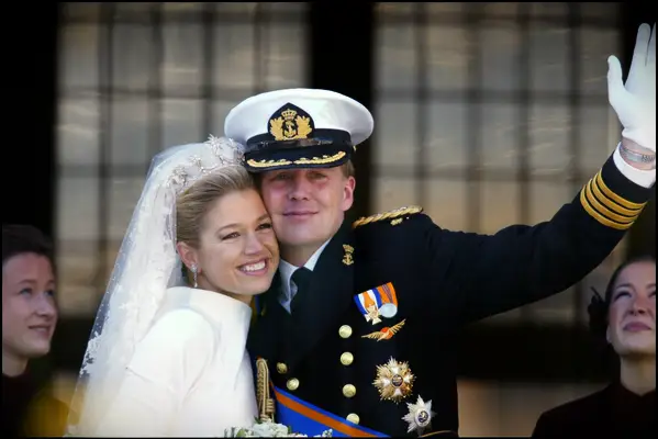 Bride wears a sparkling tiara embellished with pearls and crystals. 