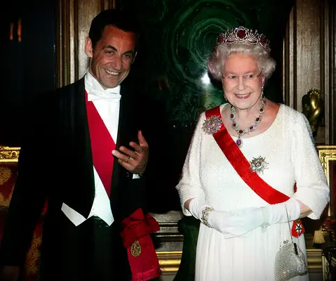 Queen Elizabeth wears a tiara embellished with rubies. 