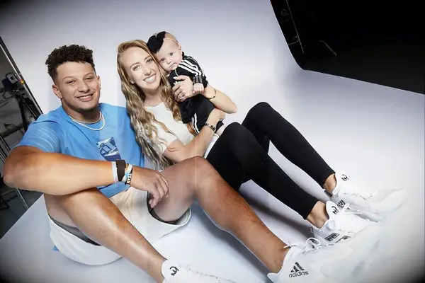 Brittany and Patrick smile with their infant daughter. 