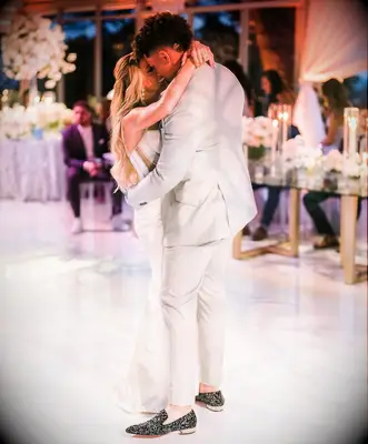 Brittany and Patrick dance at their wedding while guests watch. 
