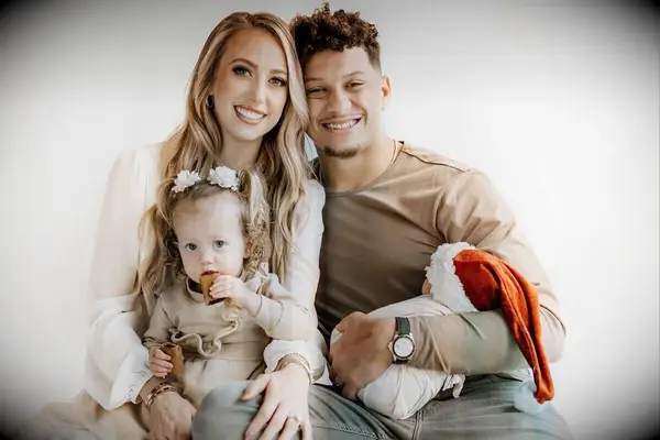 Brittany and Patrick smile with their daughter and newborn son. 