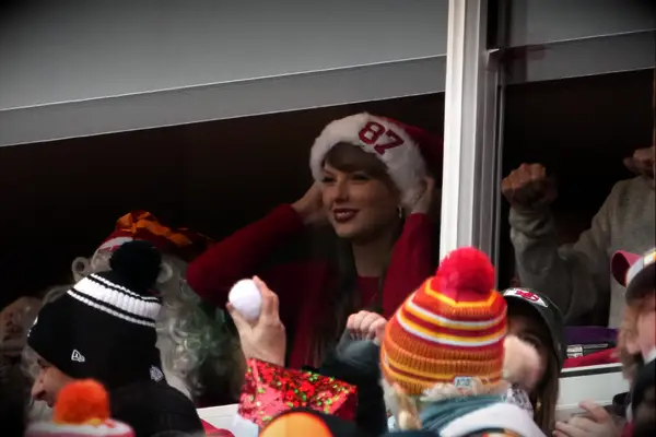 Taylor Swift wearing a #87 santa hat 