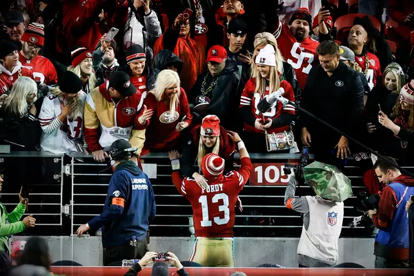 NFL Star Brock Purdy and Fiancée Jenna Brandt embrace after a game