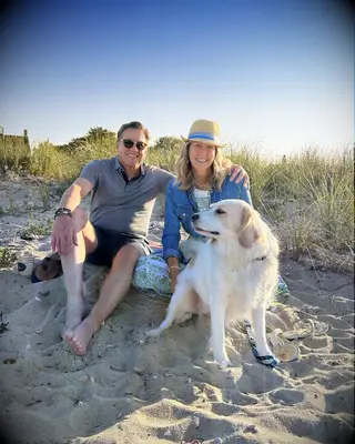Lara Spencer and Rick McVey on the beach with their dog