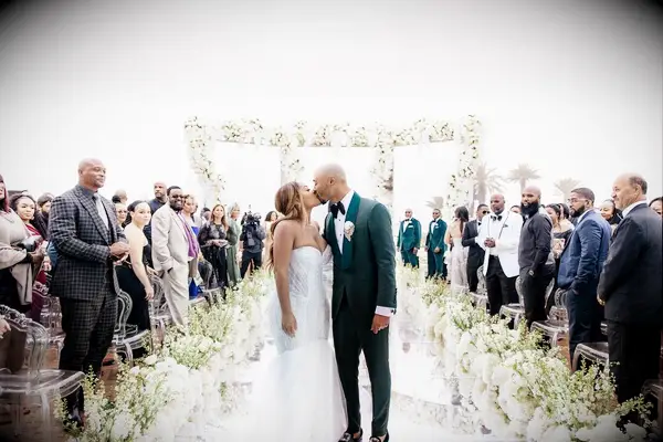 Mookie Betts and wife Brianna kissing at their wedding ceremonhy
