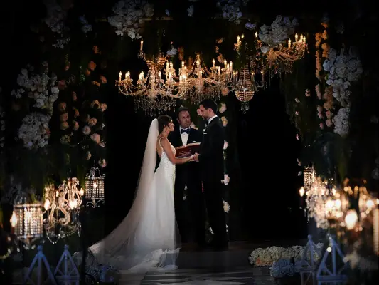 Bachelor in Paradise couple Jade Roper and Tanner Tolbert exchanging vows with Chris Harrison on wedding day