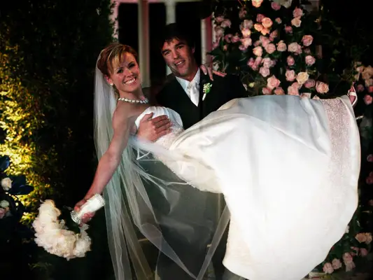  Ryan Sutter holding Bachelorette Trista Rehn on their wedding day