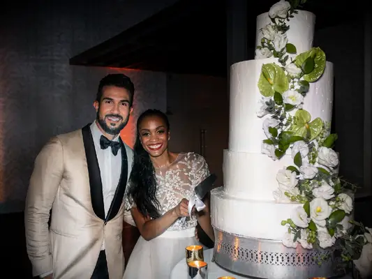 Bachelorette Rachel Lindsay cutting wedding cake with Bryan Abasolo