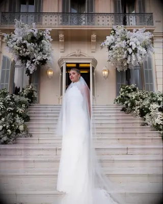 Sofia Richie standing on steps at wedding venue on wedding day