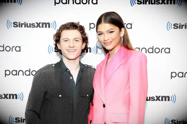 Zendaya and Tom Holland on a red carpet. 