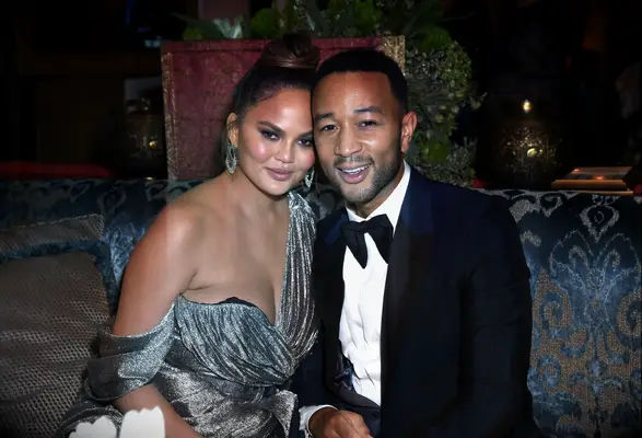 Chrissy Tiegen and John Legend smile for the camera. 