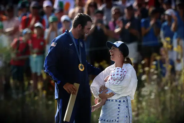Scottie Scheffler with his wife Meredith and son Bennett at the Olympics