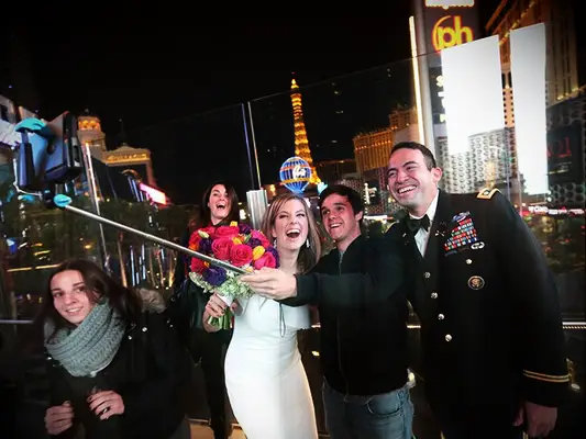 Brianna Keilar and Fernando Lujan pose for a selfie with Las Vegas tourists
