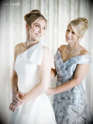 Jenna Adams putting on her wedding dress with her mom