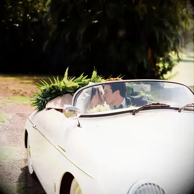 Keleigh Sperry and Miles Teller kissing in a car at their wedding