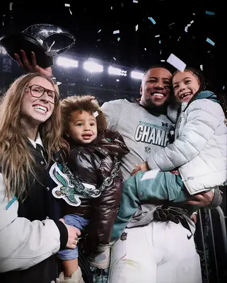 Anna Congdon and Saquon Barkley with their children at the Super Bowl
