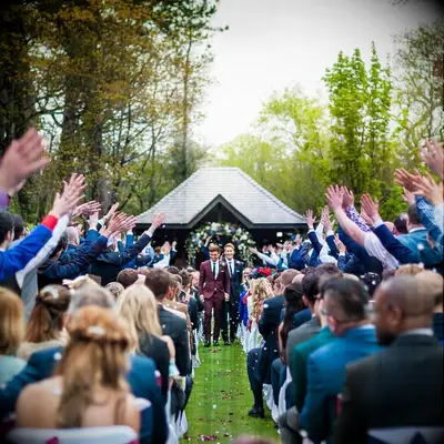 Tom and his husband walking down the aisle after exchanging their vows