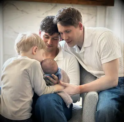 Tom and his husband with their kids