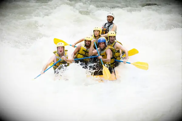 group white-water rafting in river