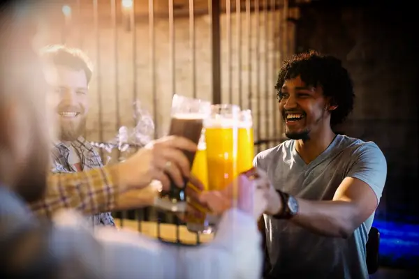 A groom raises a glass with his best friends.