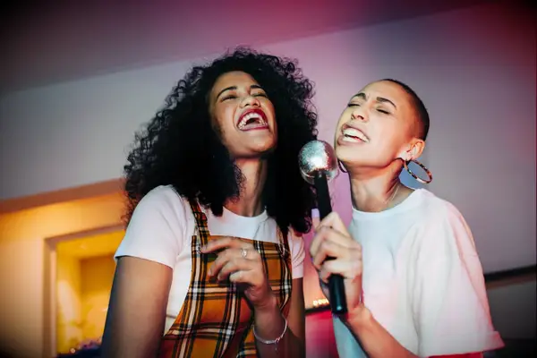 Friends singing karaoke at bachelorette party