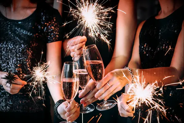 Friends toasting at bachelorette party with sparklers