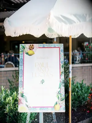 Rehearsal Dinner Welcome Sign With Lemon, Blue Patterns, Flower Designs and a Parasol