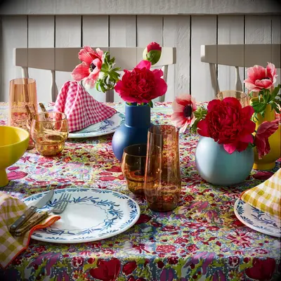 Colorful floral tablecloth rehearsal dinner decor