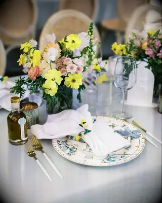 Blue-and-White Charger Plates, Blue Linen and Low Bright Centerpiece With Lemon Napkin Ring Rehearsal Dinner Decor Inspiration