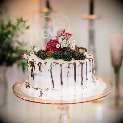 Engagement cake decorated with fruit and drizzled with chocolate