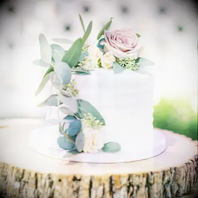 Small white engagement cake decorated with flowers