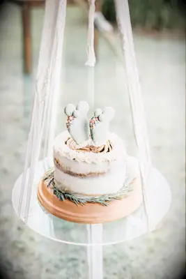 Engagement cake decorated with cacti made of macarons