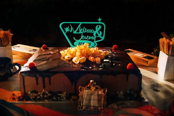 Chocolate engagement cake with retro cake topper featuring couple