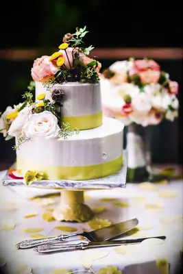 Two tier petals and prosecco cake with yellow ribbon