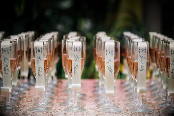 Pink rose in flutes with escort cards