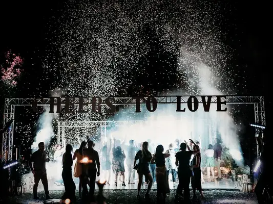 People dancing at night with confetti in the air