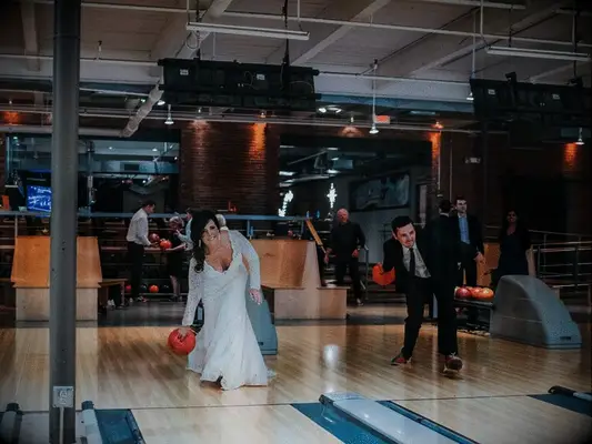 Bride and husband bowling together