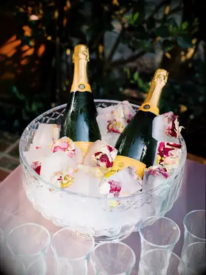 Champagne on ice with edible flowers.