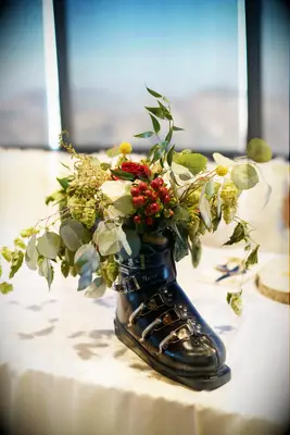 Ski boot centerpiece with greenery for winter bridal shower