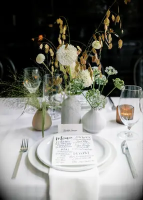 Bespoke white place setting at rehearsal dinner