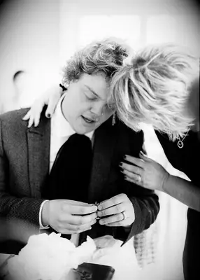 Two people exchanging gifts at rehearsal dinner
