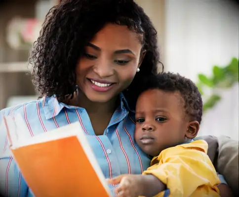 Babysitter and child reading a book