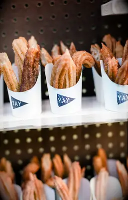 Mini servings of churros at a bridal shower. 